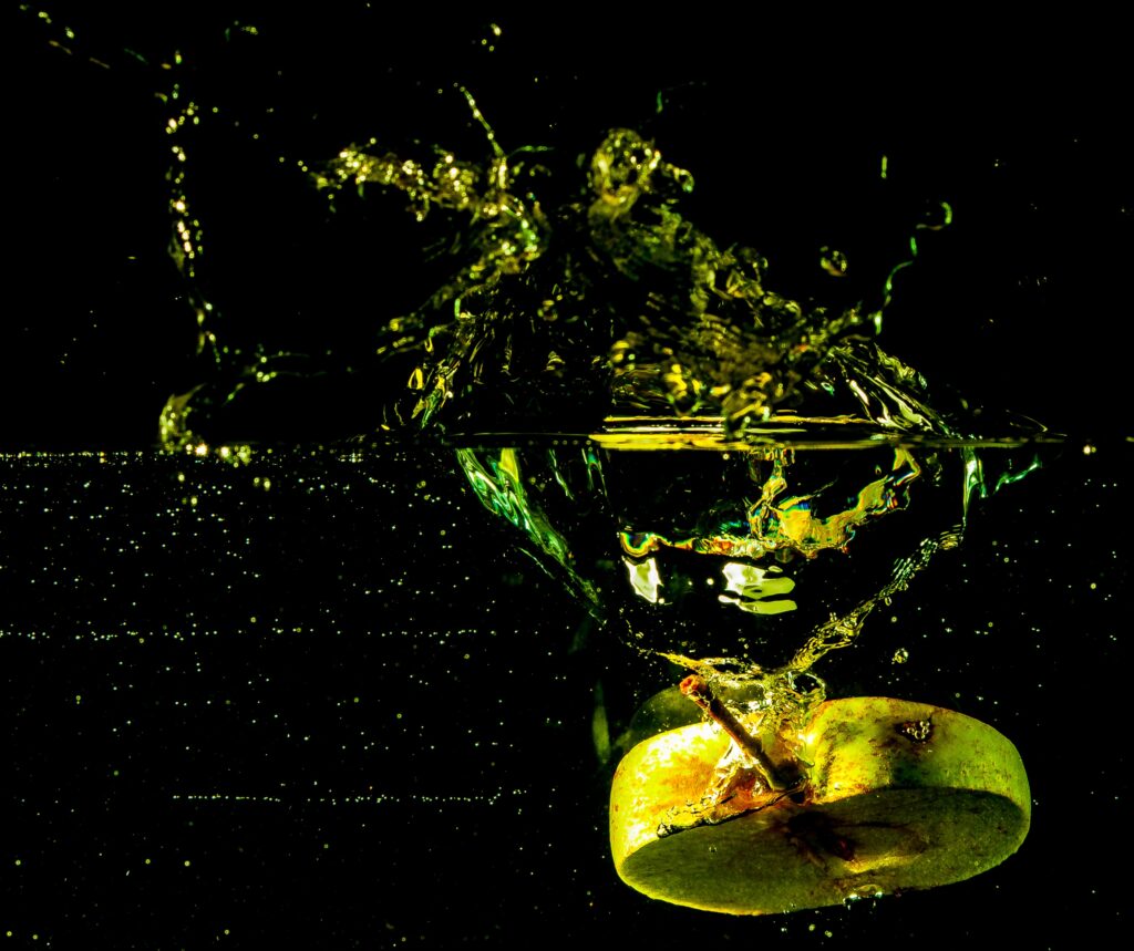 Dynamic Apple Splash: Vibrant Close-Up Wallpaper on Dark Background