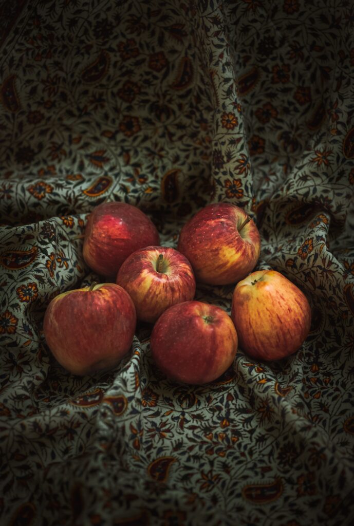 Vibrant Red Apple Wallpaper: Fresh Harvest on Charming Fabric Background