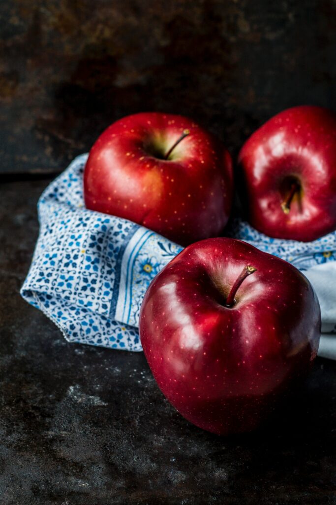Fresh Red Apples on Blue Cloth | Vibrant Fruit Wallpaper Background