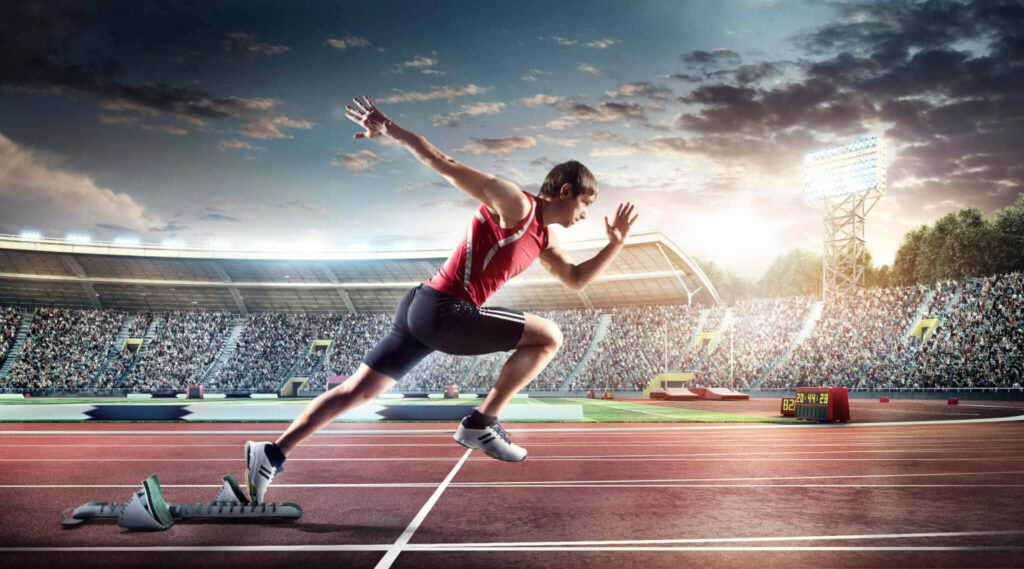Dynamic Male Athlete Sprinting Wallpaper - Vibrant Stadium Background
