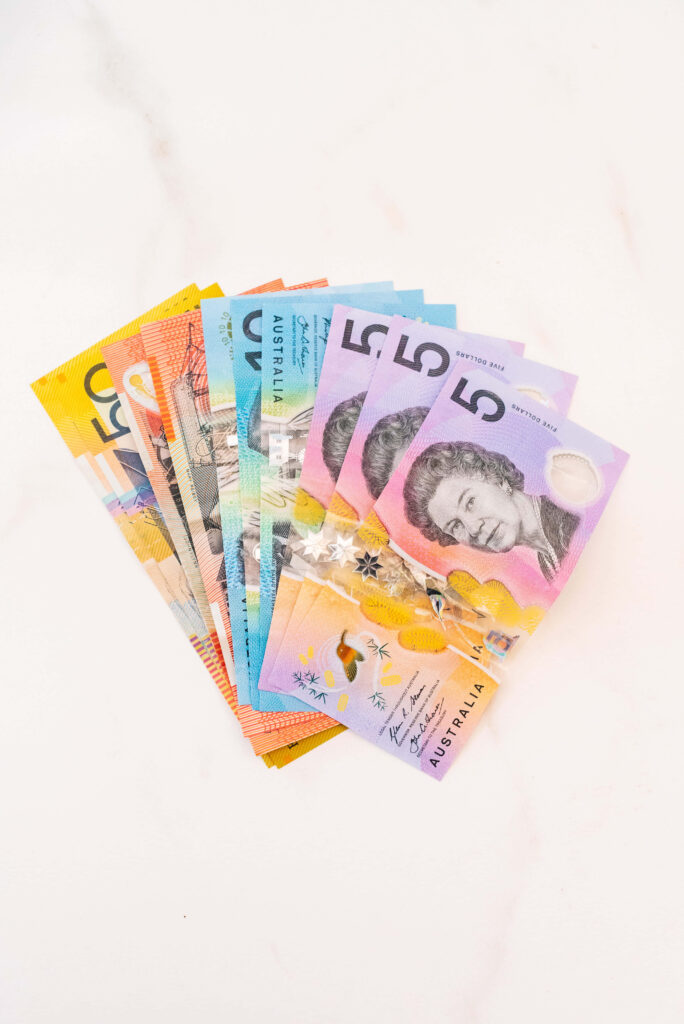 Colorful Australian Dollar banknotes fanned out showing modern currency design wallpaper