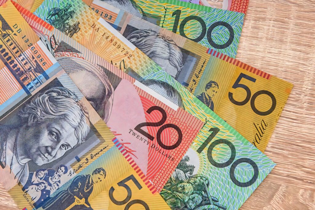 Colorful Australian dollar banknotes spread on wood showcasing unique currency designs and details Wallpaper