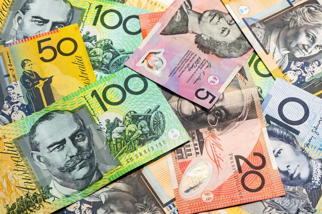 Vibrant Australian dollar banknotes overlapping with historical figures in colorful wallpaper background