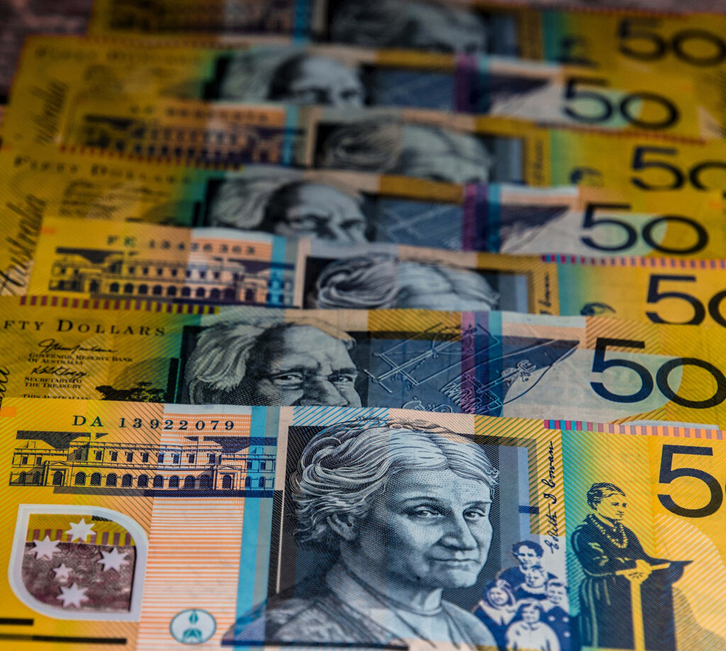 Vibrant stack of Australian fifty dollar banknotes with detailed artwork and security features wallpaper