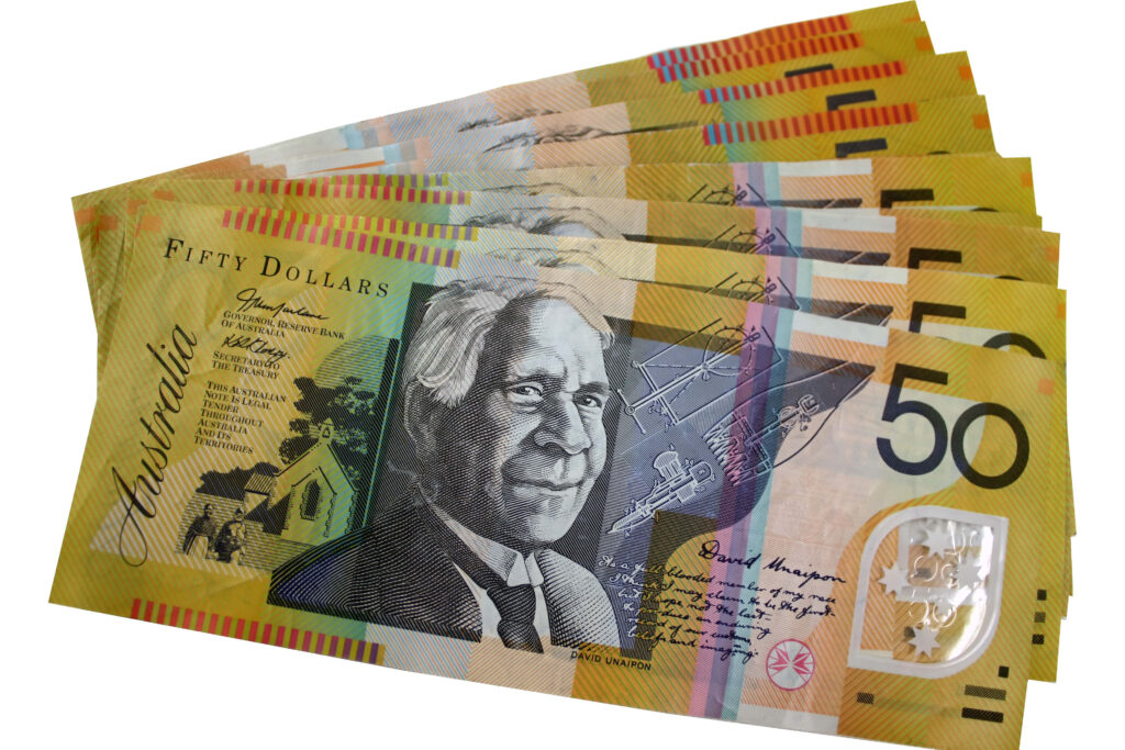 Stack of colorful Australian fifty dollar notes with detailed portraits ideal for wallpaper background