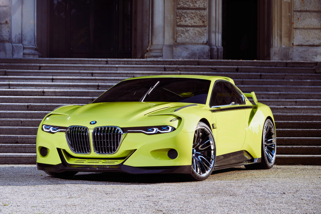 Vibrant BMW CSL Hommage: Futuristic Design Against Classic Architecture Wallpaper