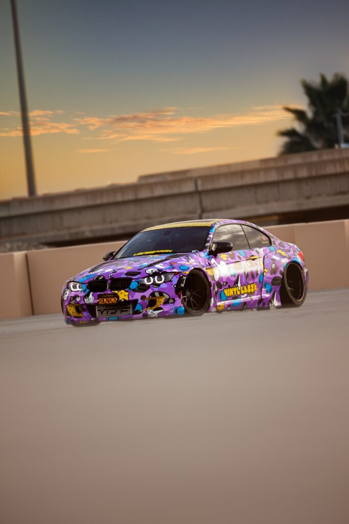Vibrant BMW Mid-Drift: Thrilling Racing Scene with Purple Sunset Wallpaper