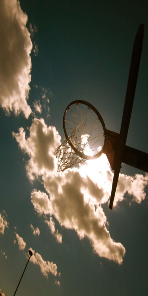 “Motivational Sports Wallpaper: Basketball Hoop & Vibrant Sky”