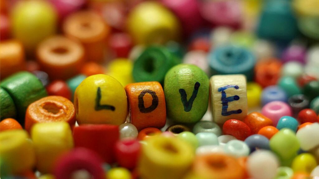 Vibrant Beads Wall Art: Cheerful LOVE Design Wallpaper Background