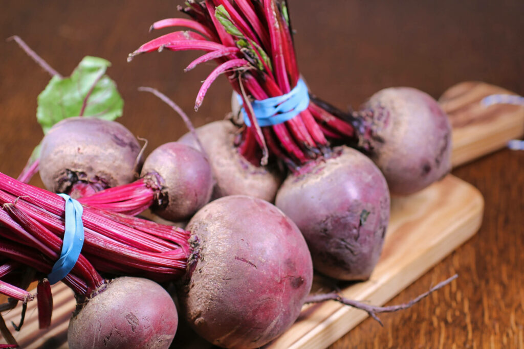 Vibrant Beetroot Wallpaper: Fresh Bundles on Rustic Wooden Surface