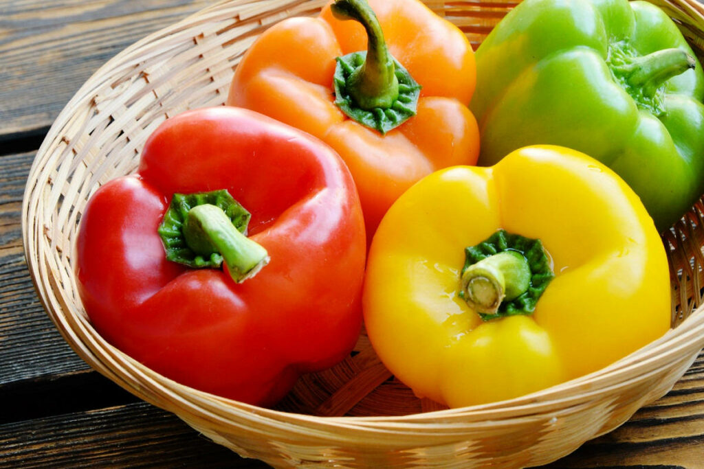 Colorful Fresh Bell Peppers in Rattan Basket - Rustic Wallpaper