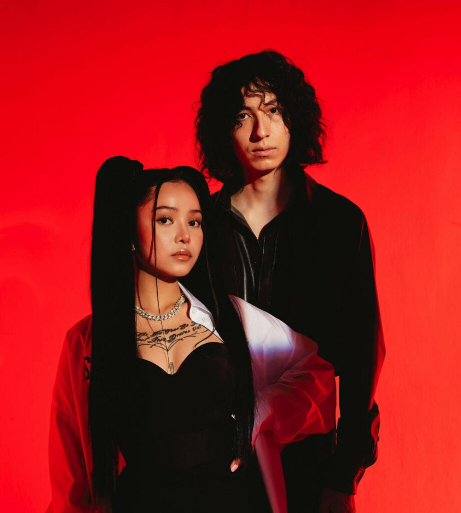 Vibrant Wallpaper of Bella Poarch & Sub Urban on Red Background