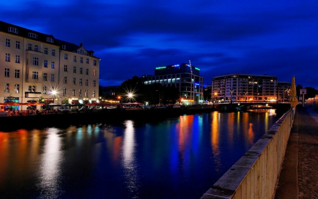 Vibrant Berlin Nightlife Wallpaper: Illuminated Riverside Charm