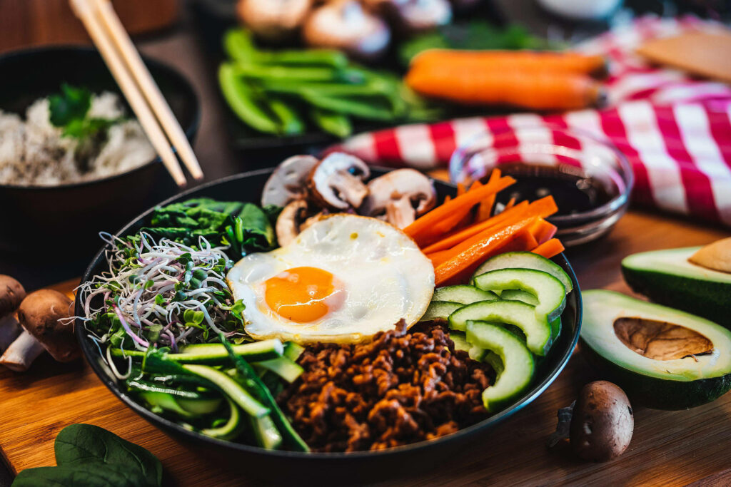 Vibrant Bibimbap Wallpaper: Fresh Veggies & Egg Healthy Background