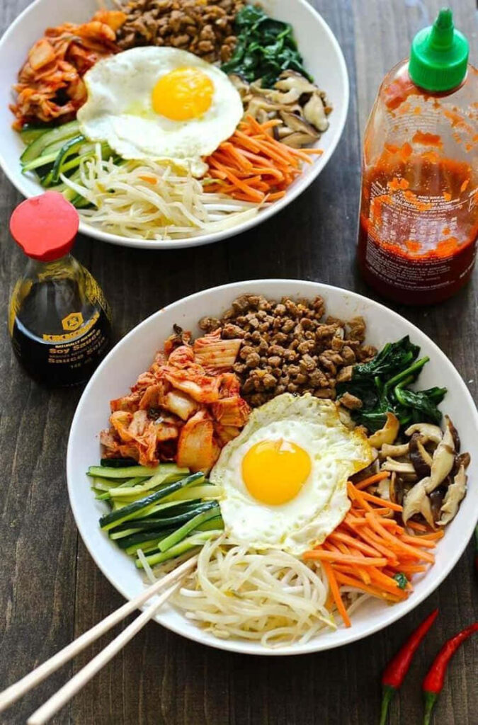 Vibrant Bibimbap Wallpaper: Fresh Korean Bowls on Rustic Table
