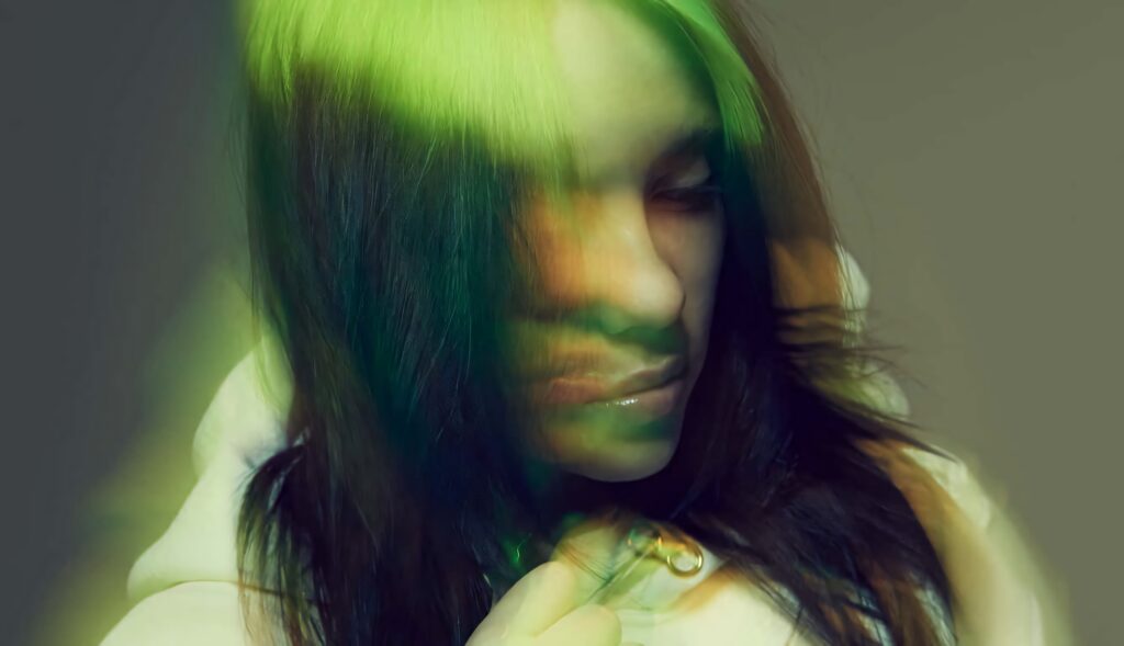 Billie Eilish Vibrant Wallpaper: Ethereal Green & Yellow Background