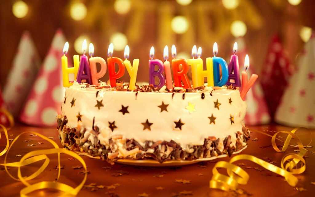 Cheerful Birthday Cake Wallpaper with Colorful Candles & Lights