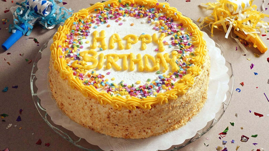 Vibrant Birthday Cake with Sprinkles & Cheerful Yellow Icing Wallpaper