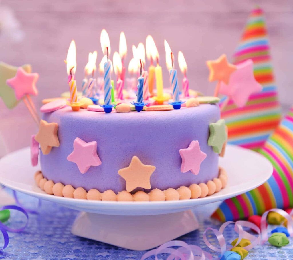 Vibrant Birthday Scene with Pastel Cake, Candles & Decorations Wallpaper