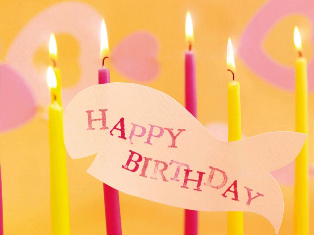 Festive Fish-Shaped Birthday Wallpaper with Colorful Candles