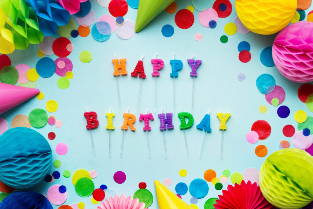 Festive Birthday Wallpaper with Colorful Candles & Confetti