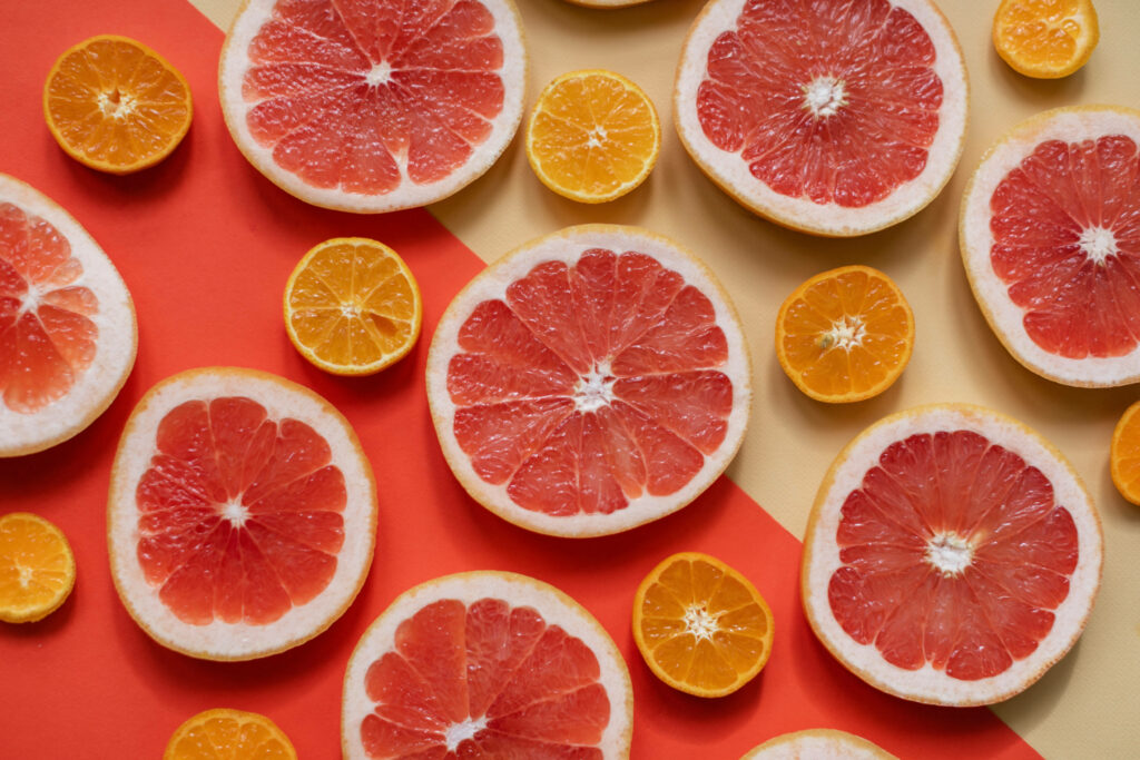 Vibrant blood orange and citrus fruit slice pattern on colorful fresh energetic wallpaper background