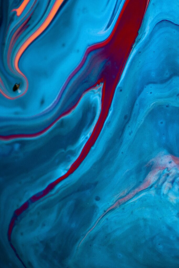 Vibrant Abstract Blue Wallpaper with Fluid Red Paint Patterns