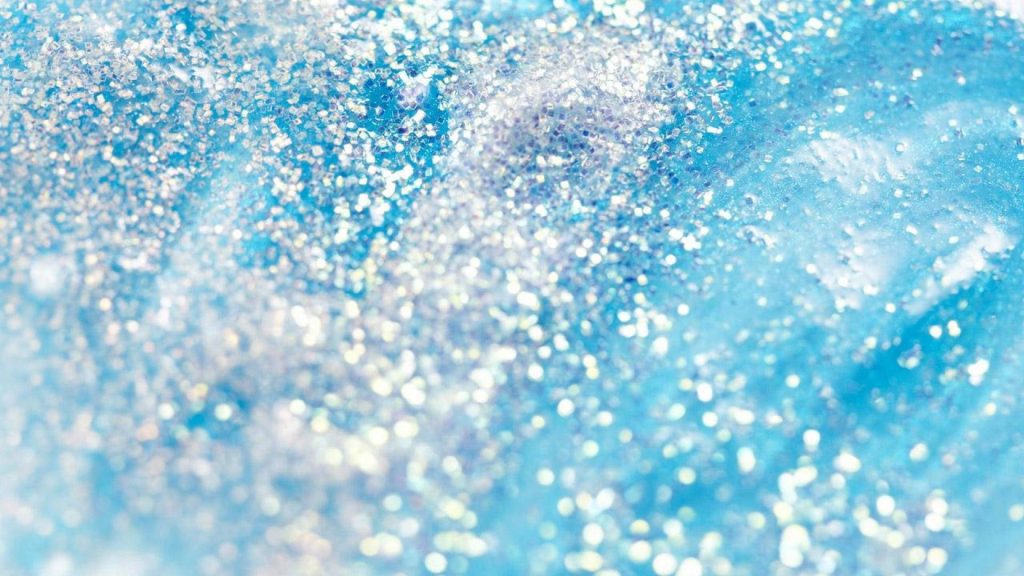 Abstract blue textured wallpaper with shimmering white silver glitter and sparkling bokeh effect
