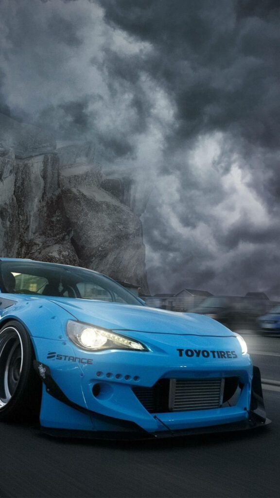 Vibrant blue custom car speeding on road under dramatic cloudy sky 4K iPhone wallpaper background