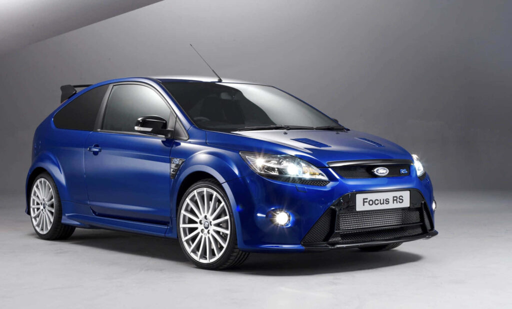 Vibrant blue Ford Focus RS in studio showcasing sporty design aggressive stance wallpaper