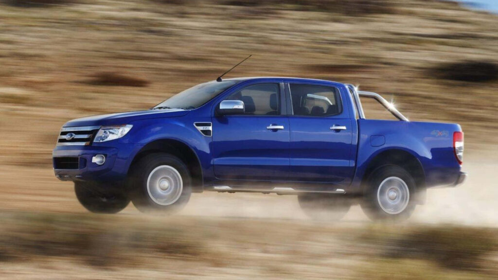Blue Ford Ranger driving fast through rugged terrain showcasing power and durability wallpaper