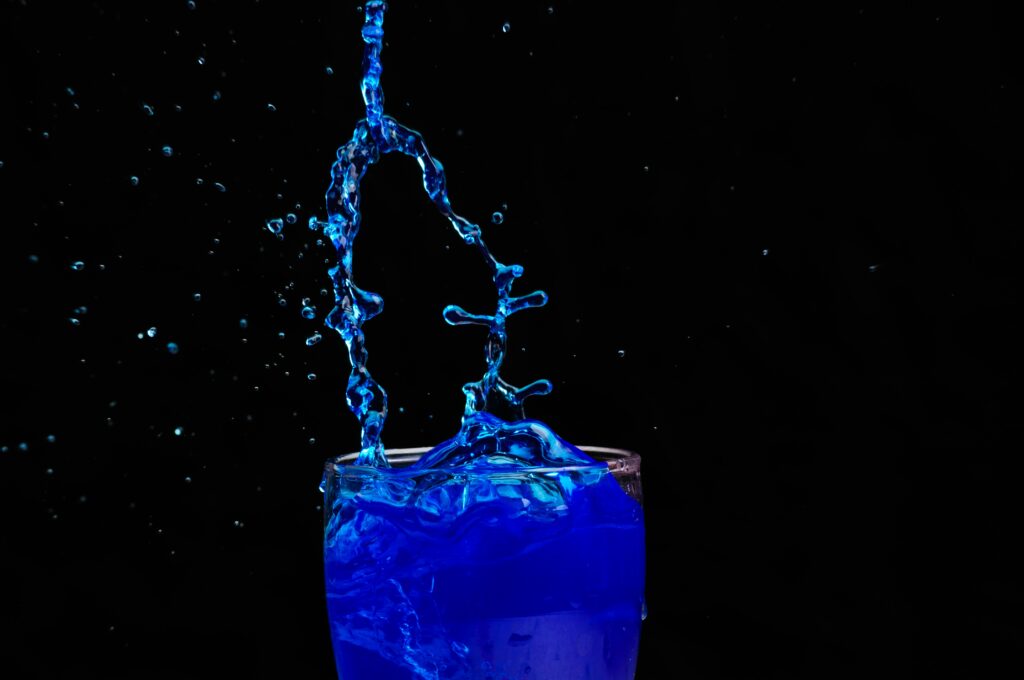 Vibrant Blue Liquid Splash Wallpaper on Dark Background