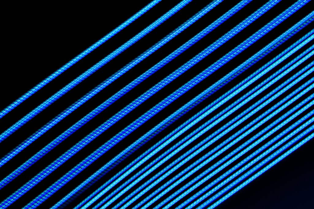 Vibrant Blue Neon Stripe Wallpaper on Black - Modern Background Design
