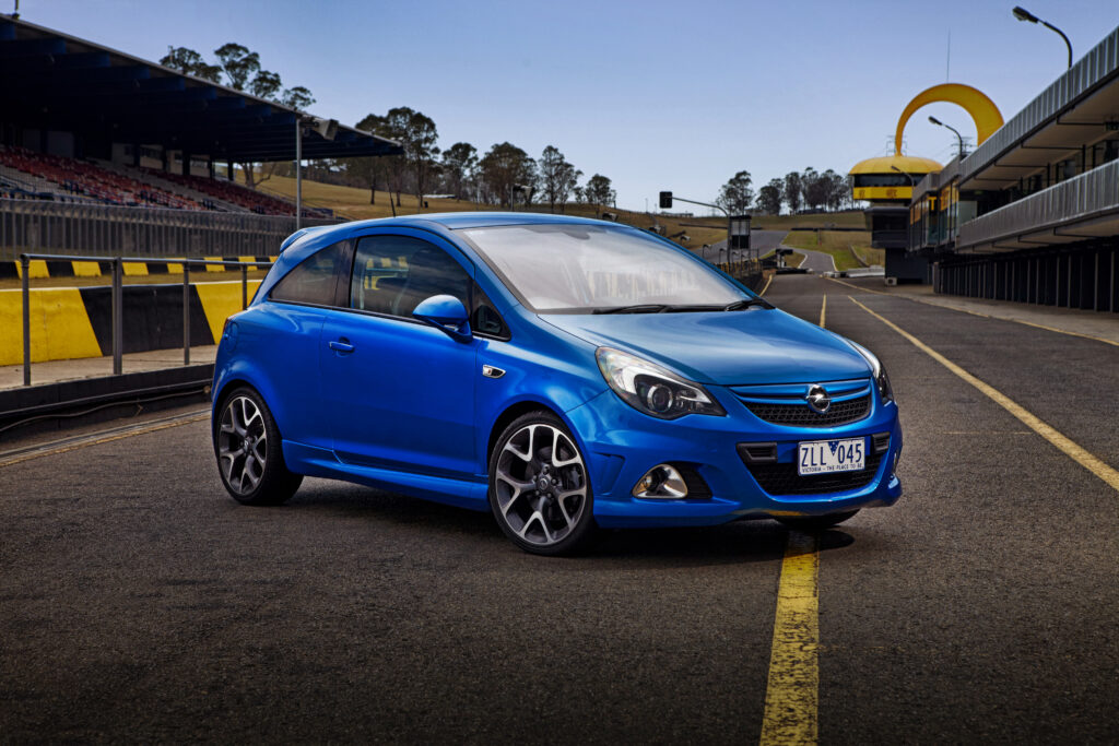 Vibrant Blue Opel Corsa on Racetrack - Sporty Wallpaper for Enthusiasts