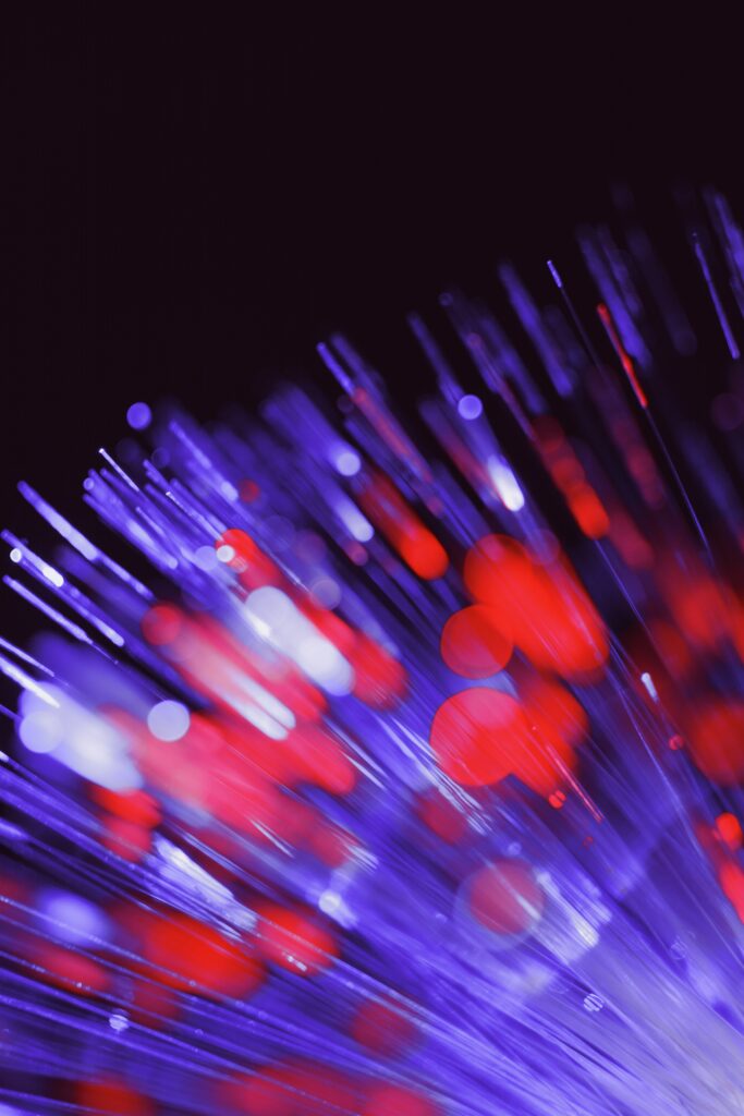 Vibrant Optical Fiber Wallpaper: Glowing Blue & Red Bokeh Background