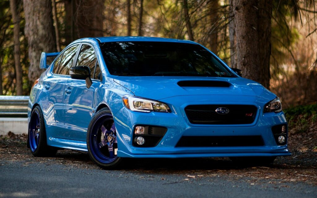 Dynamic Blue Subaru WRX STI Wallpaper with Nature Background