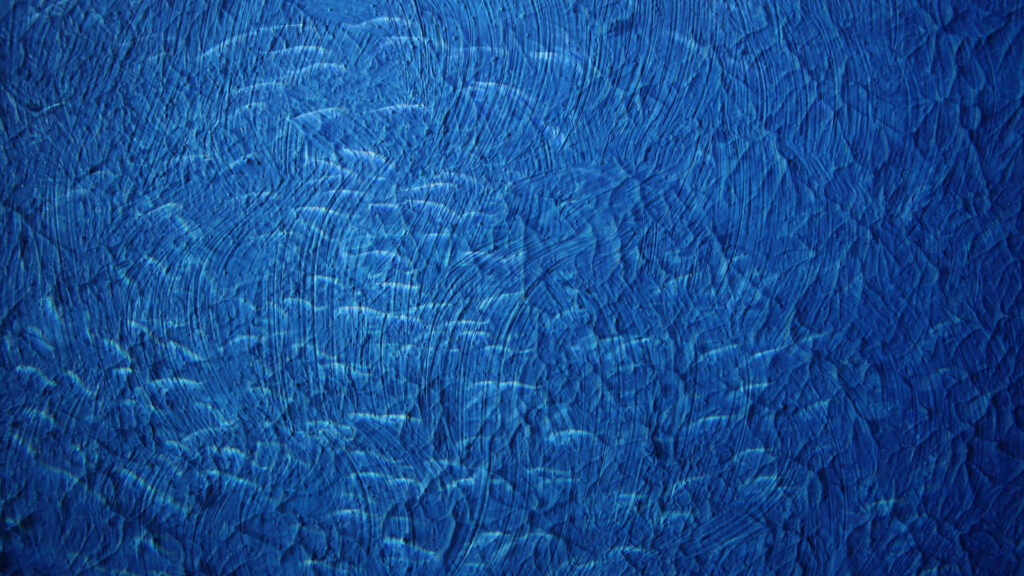 Vibrant Blue Textured Wallpaper with Artistic Brushstroke Patterns