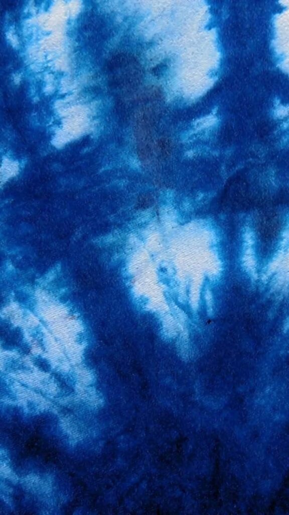 Vibrant blue tie-dye wallpaper with abstract watercolor texture and dynamic organic shapes background