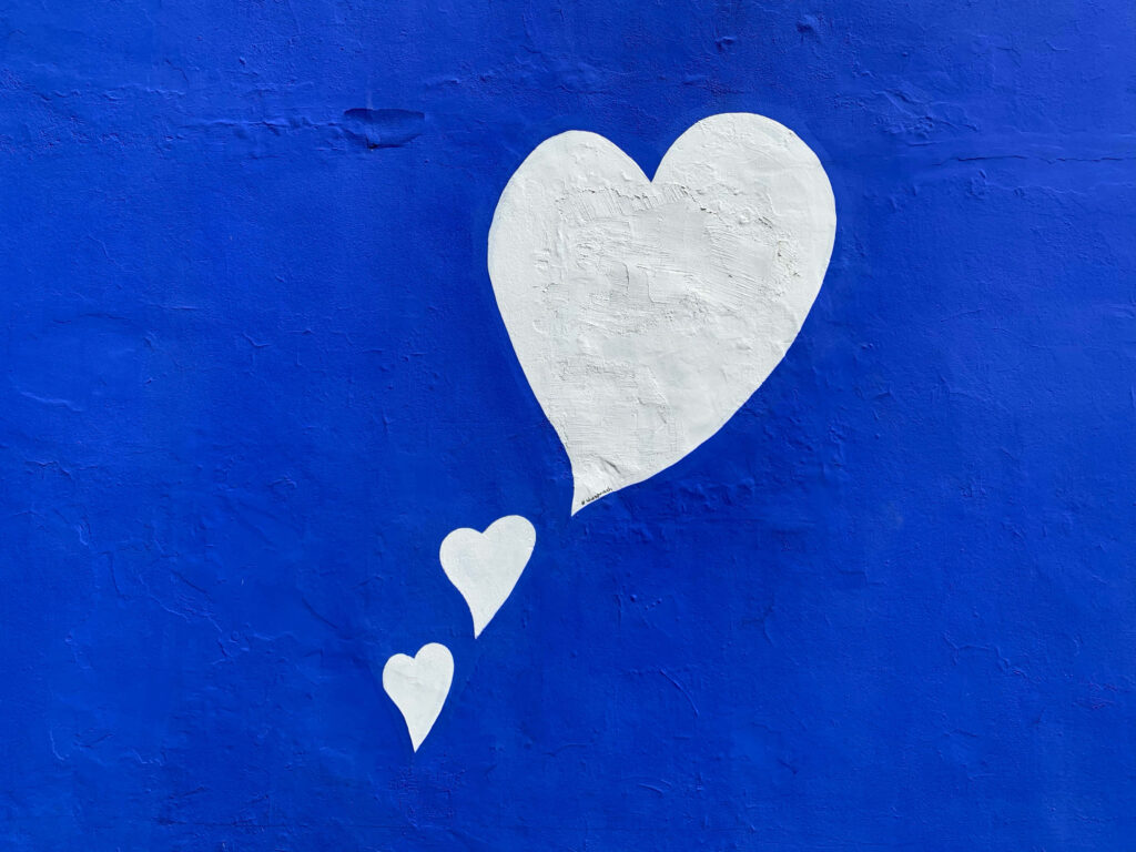 Vibrant Blue Wall with Heart Design - Captivating Wallpaper Background
