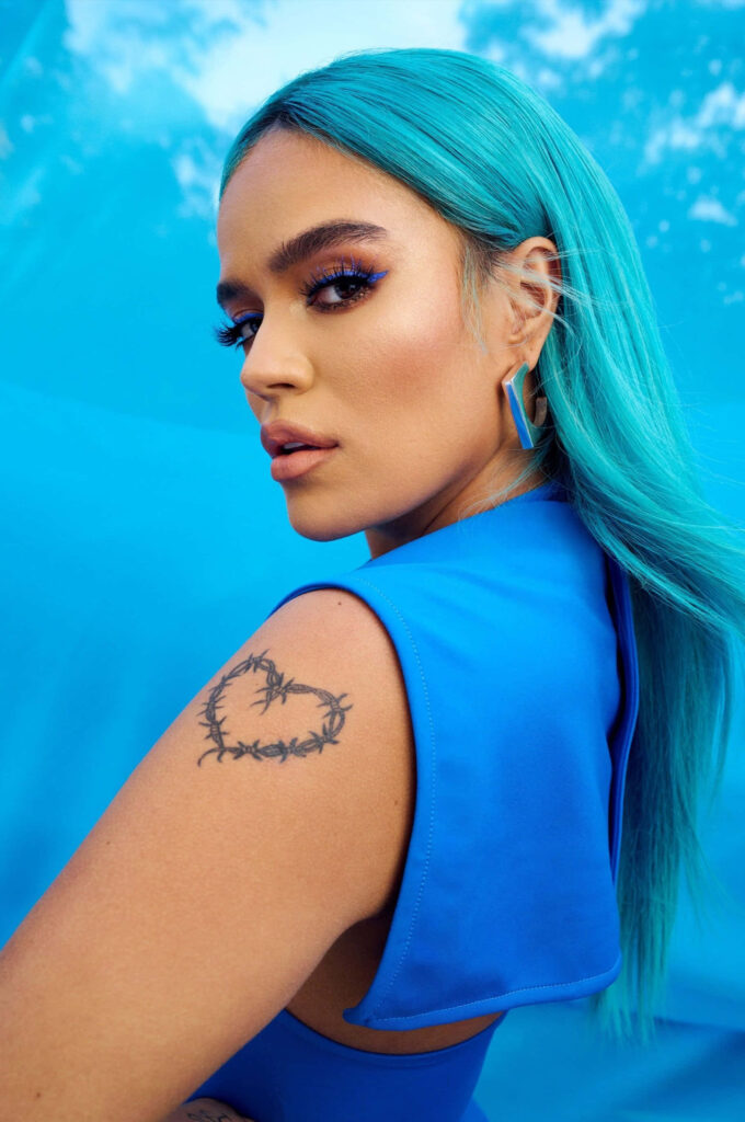 Vibrant Blue Wallpaper: Confident Woman in Bold Makeup & Style