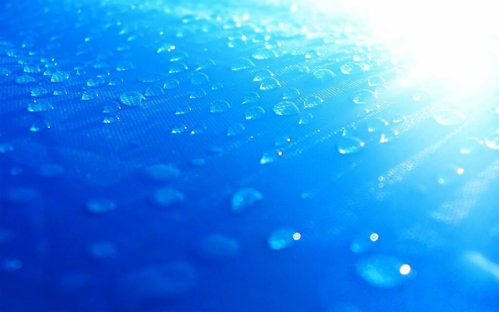 Refreshing Blue Wallpaper with Water Drops and Bright Light Rays