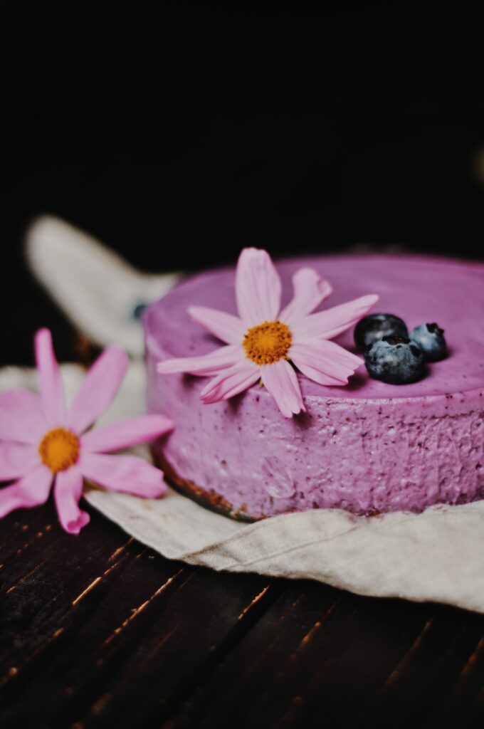 Vibrant Blueberry Cheesecake Wallpaper with Fresh Flowers & Rustic Charm