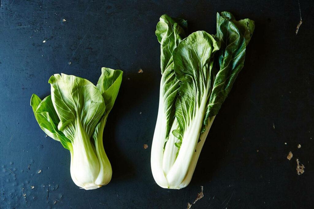 Vibrant Bok Choy Wallpaper: Fresh Green Vegetables on Dark Background
