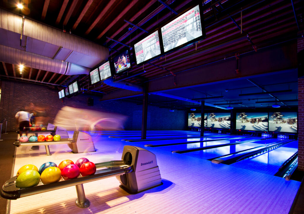 Vibrant bowling alley wallpaper with colorful balls illuminated lanes and modern nightlife vibe