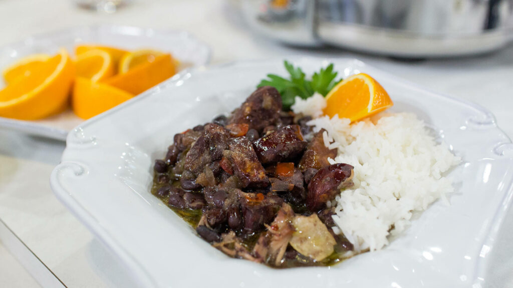 Vibrant Feijoada: Brazilian Black Bean Stew with Rice & Orange Slice Wallpaper