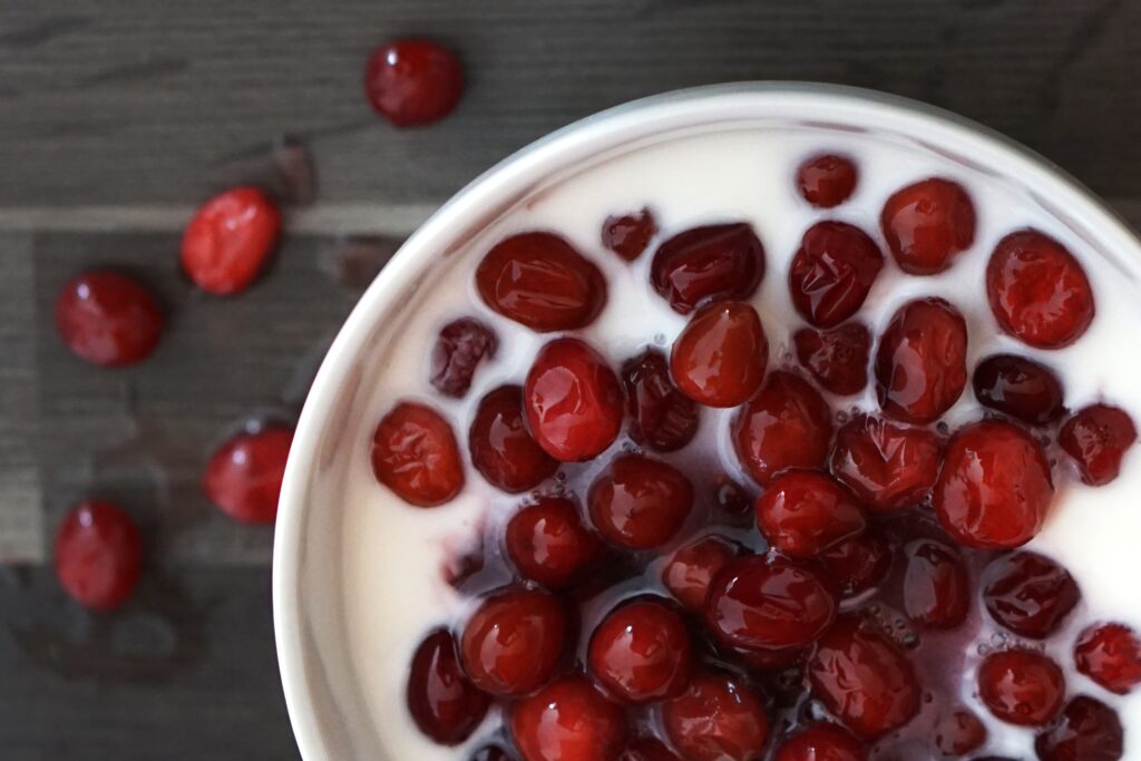 Vibrant Breakfast: Fresh Cranberries on Creamy Yogurt Wallpaper