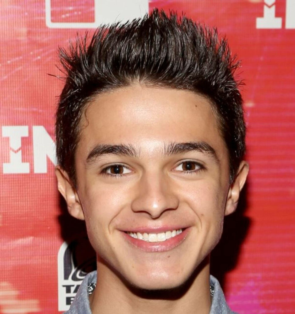 Brent Rivera vibrant wallpaper confident smile red patterned background youthful celebrity style