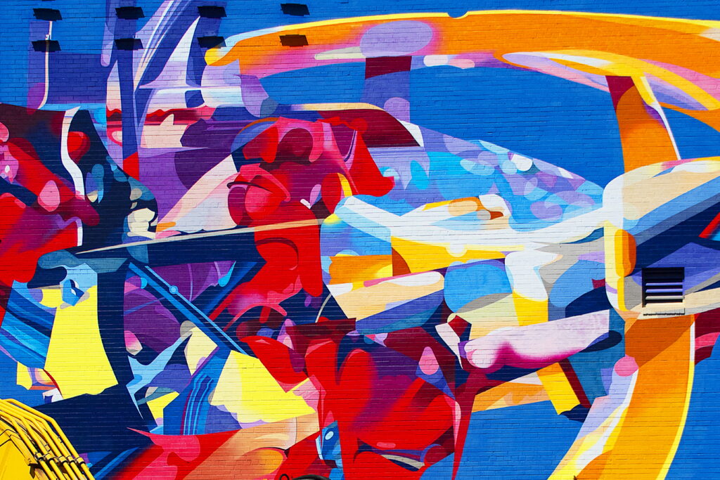 Vibrant Bricks: Captivating Graffiti Art adorns Textured Wall in HD Wallpaper Background