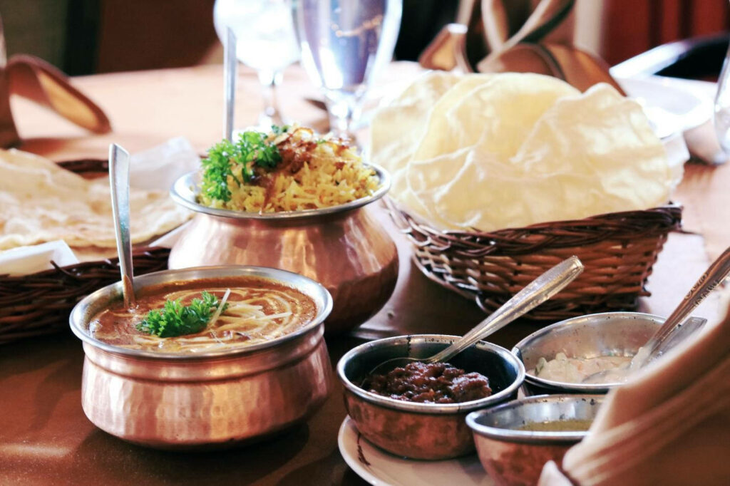 Vibrant Brunei Cuisine Wallpaper: Curry, Biryani & Rustic Utensils