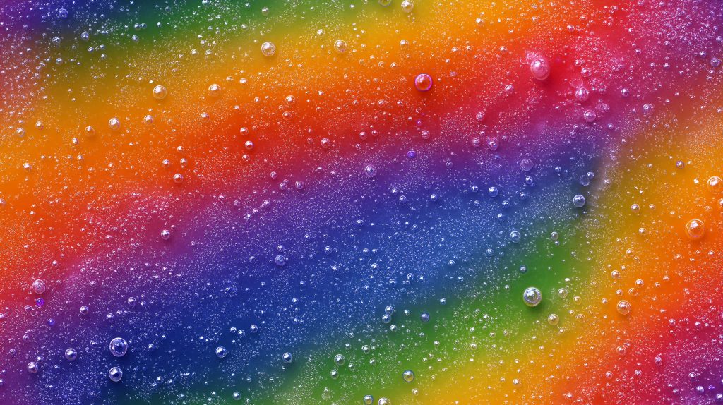 Vibrant bubbly spectrum wallpaper with vivid rainbow gradient and shimmering translucent droplets